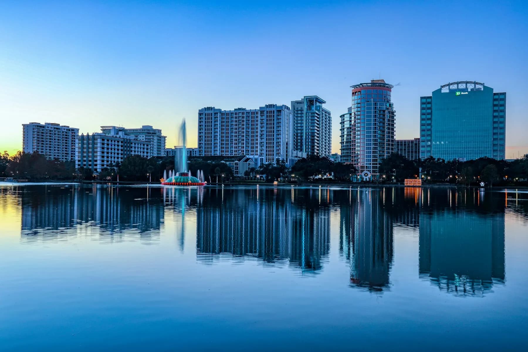 Downtown Orlando skyline and Lake Eola fountain at sunrise