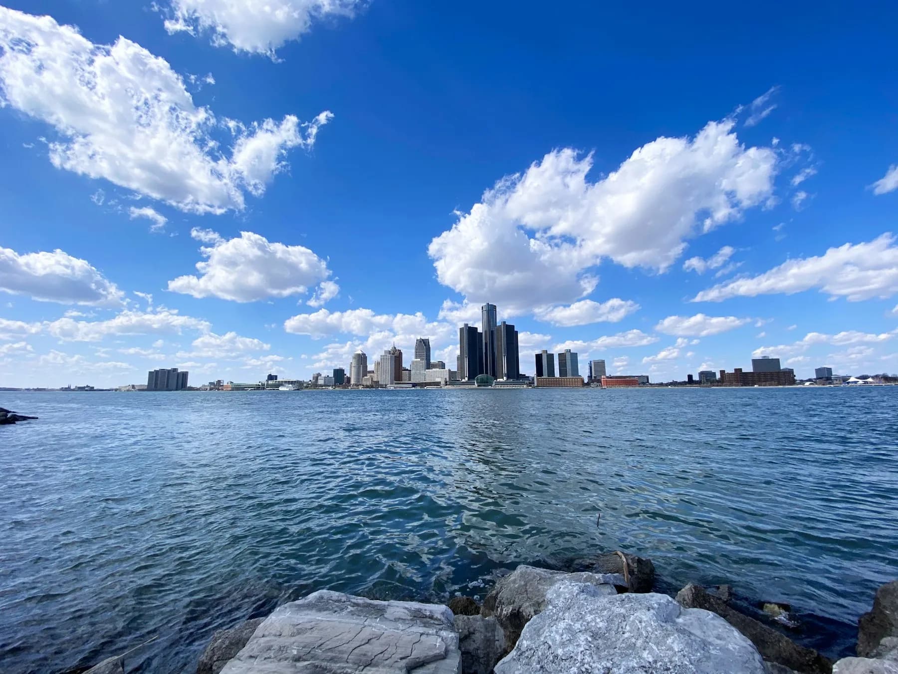 Detroit skyline across the Detroit River on a bright day